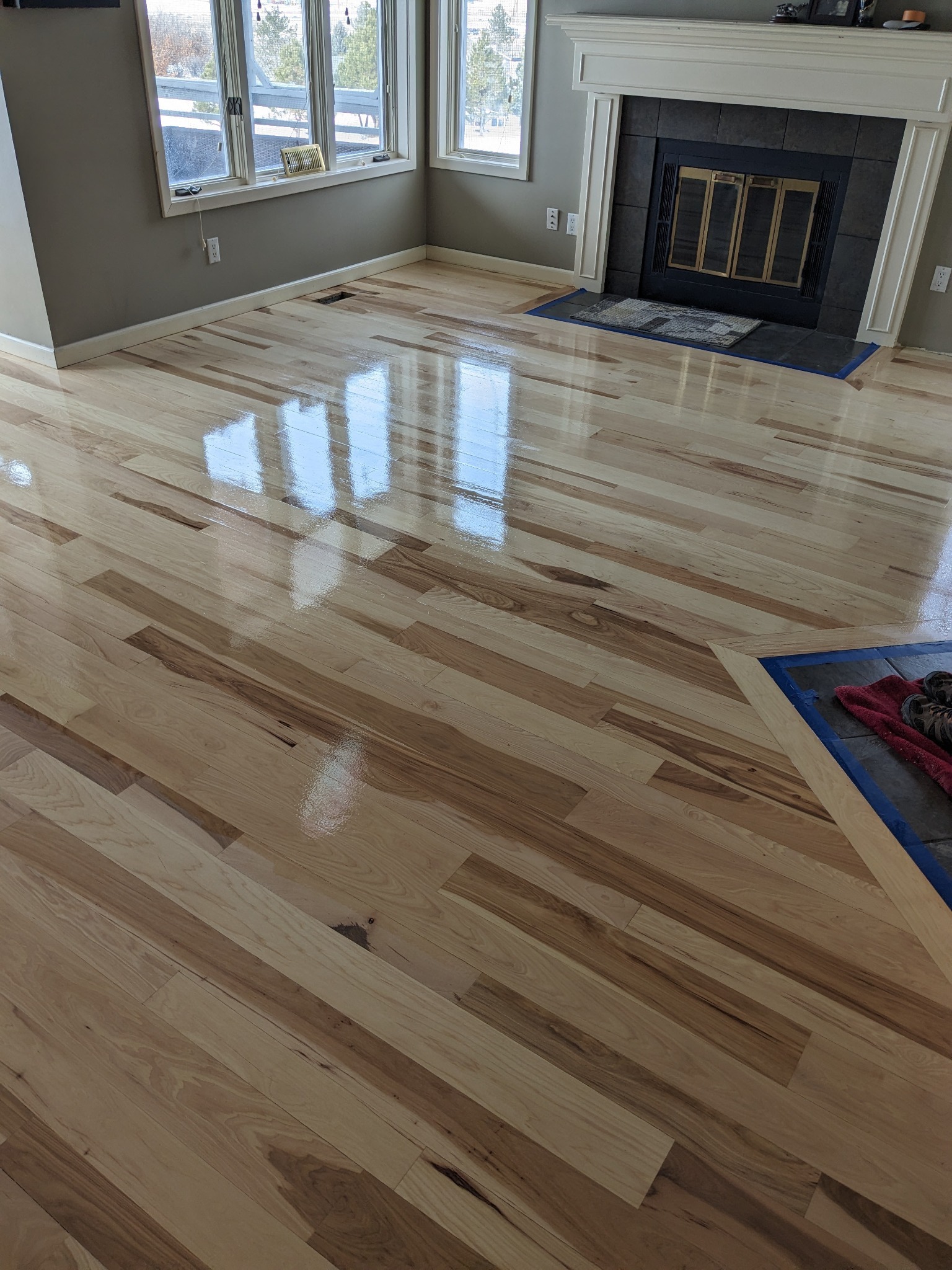Finished hardwood floor by a fireplace